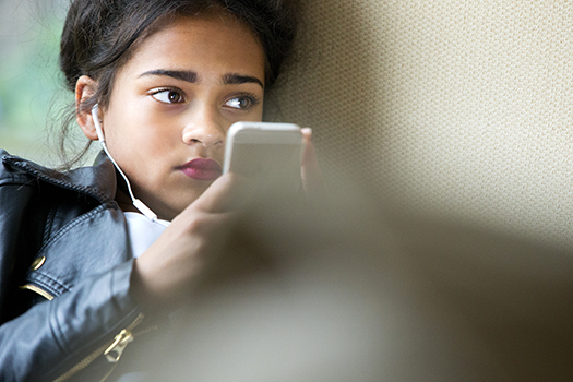Teenager on her mobile phone